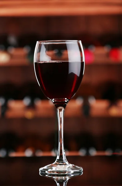 Glass of red wine on bar background