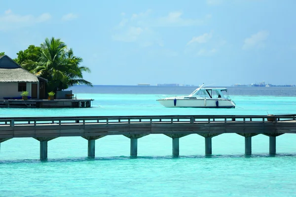 Water bridge over blue ocean in Baros Maldives