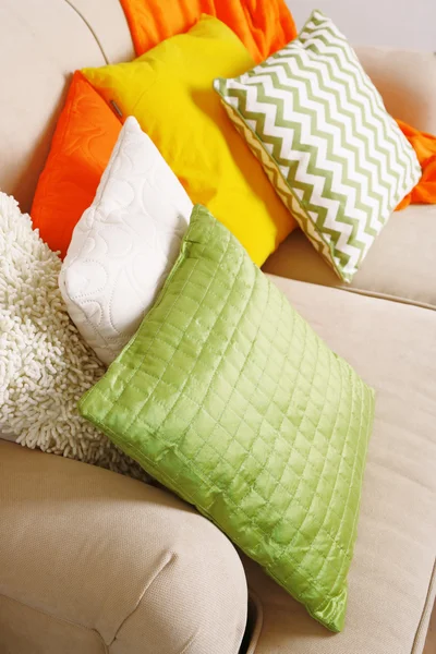 Colorful pillows on sofa close up