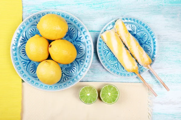 Lemons and ice cream on plates on table top view