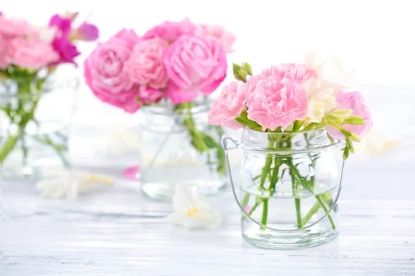 Beautiful spring flowers in glass bottles, closeup