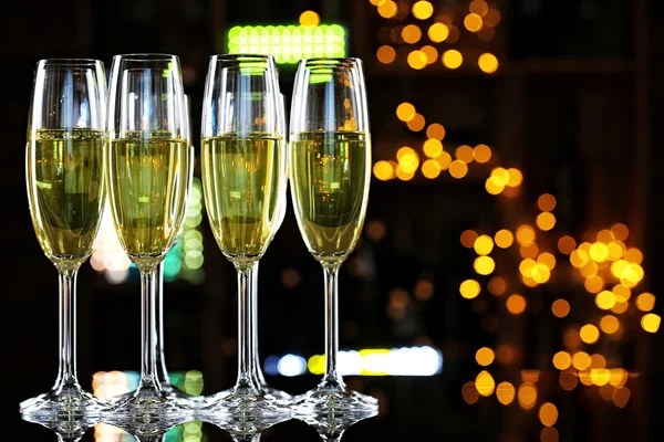 Glasses of champagne on bar background