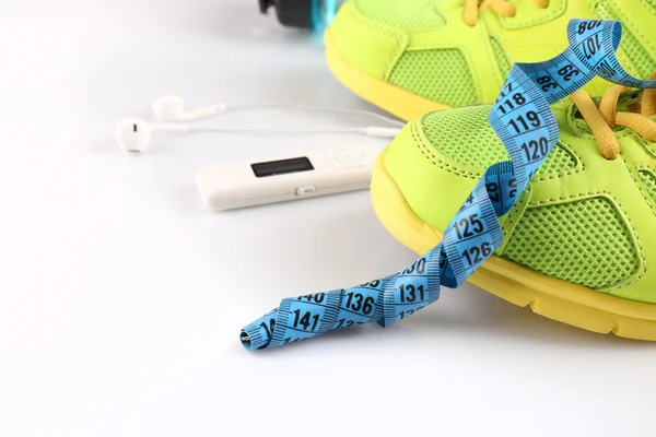 Sports shoes with measuring tape and player close up