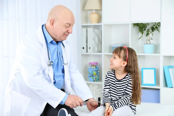 Little girl and old doctor in hospital