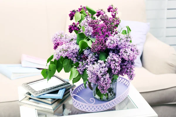 Beautiful lilac flowers in vase on table