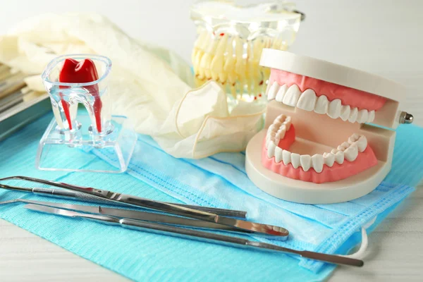 White fake teeth, prosthesis and dental instruments