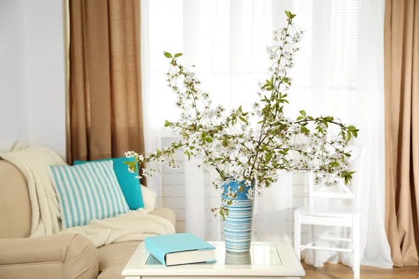 Spring bouquet in vase, on table, on home interior background