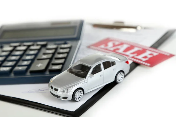 Tablet, calculator and toy car isolated on white