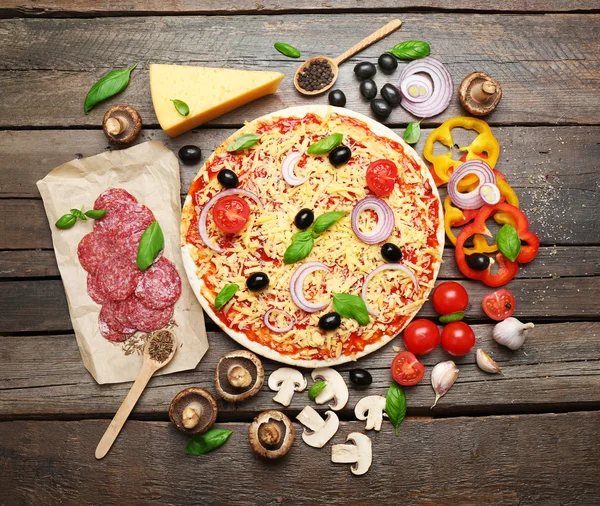 Food ingredients for pizza on table close up