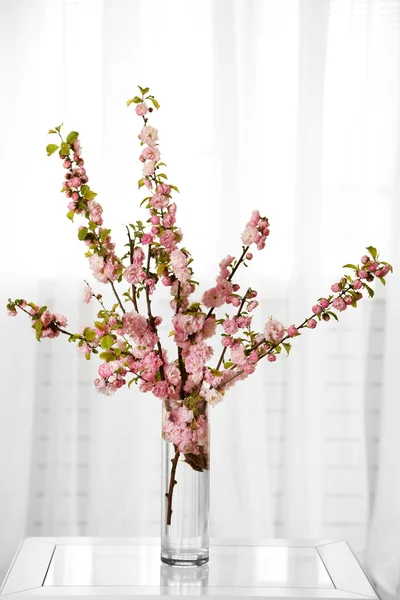 Spring bouquet in vase, on table, on home interior background