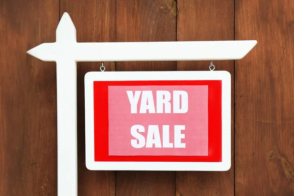 Wooden Yard Sale sign on wooden fence background