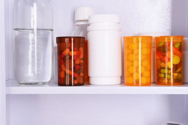 Medicine chest with bottles of pills, closeup