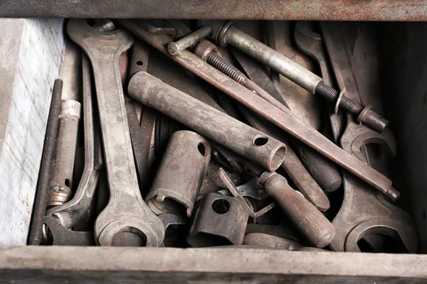 Different tools in box on workplace in garage