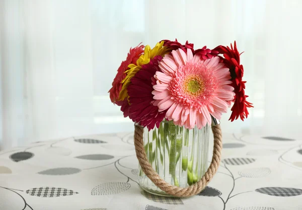 Glass vase of colorful gerbera flowers