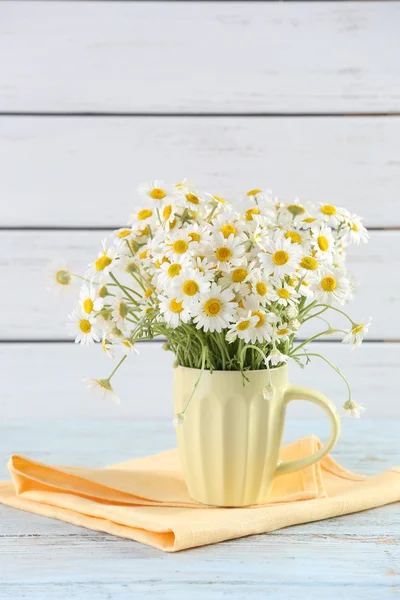 Beautiful bouquet of daisies in cup