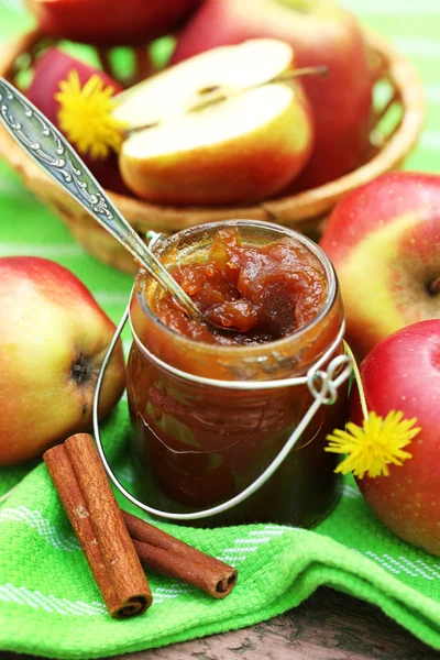 Apple jam in jar and fresh red apples