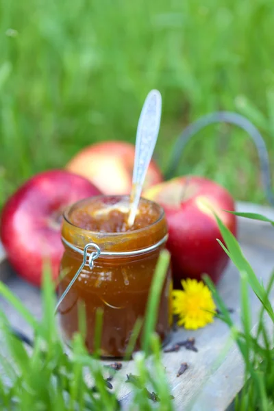 Apple jam in jar and fresh red apples