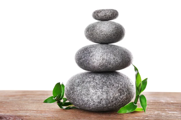 Stack of spa stones with green leaves