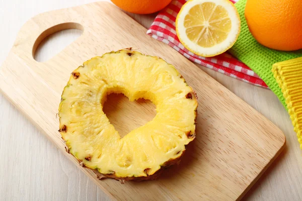 Pineapple slice with cut in shape of heart on table close up