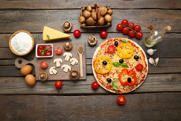 Food ingredients for pizza on table close up