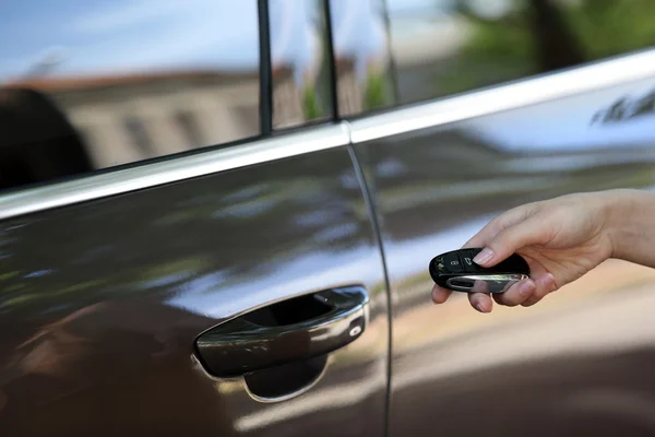 Hand presses on remote control car alarm systems