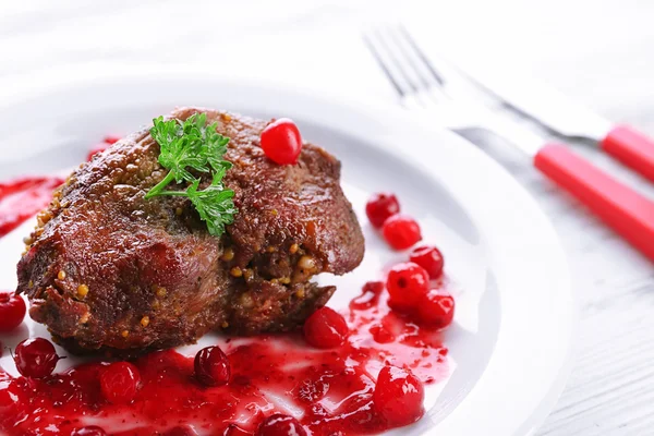 Tasty roasted meat with cranberry sauce