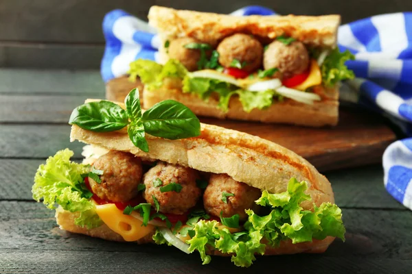 Homemade Spicy Meatball Sub Sandwich on wooden table background