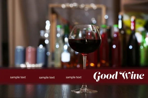 Glasses of red wine in bar on blurred background