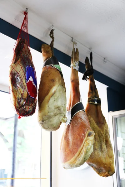 Set of ham hanging in butcher shop