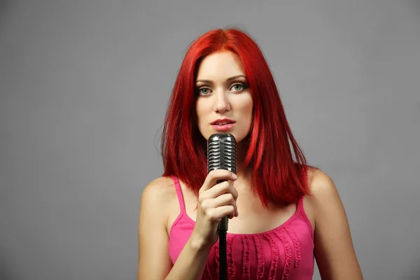 Beautiful young woman with microphone