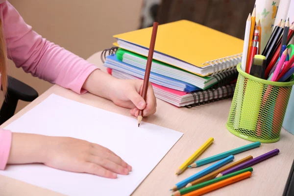 Kids hands drawing on notebook