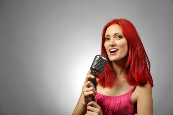 Beautiful young woman with microphone