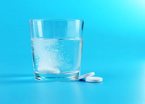 Glass of water and pills