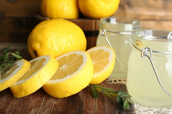 Still life with lemon juice and sliced lemons