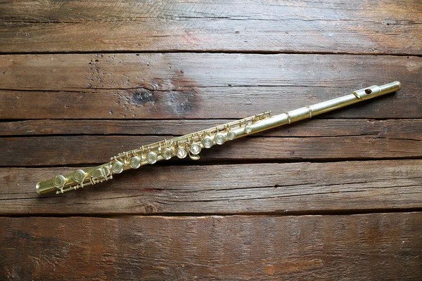 Flute on wooden background