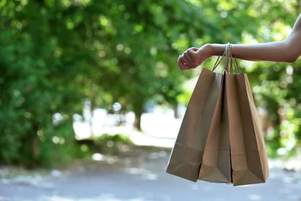 Female hand holding shopping bags