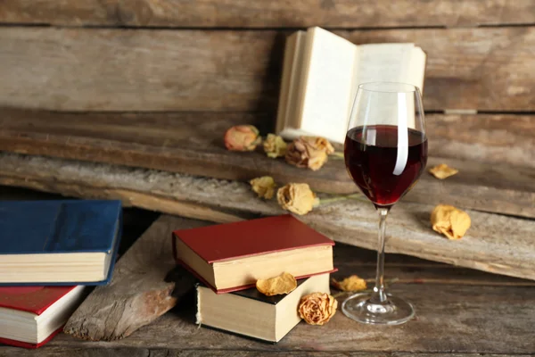 Glass of wine with old books