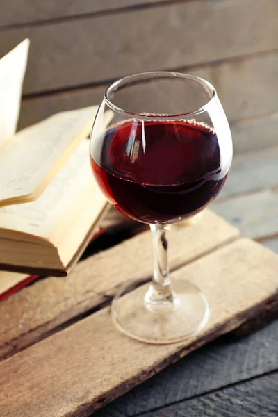 Glass of wine with old books