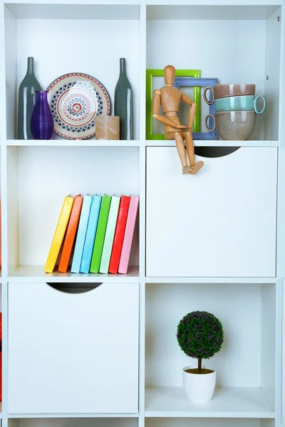 Beautiful white shelves with different home objects