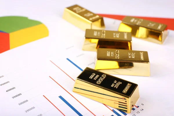 Gold bullion on documents background