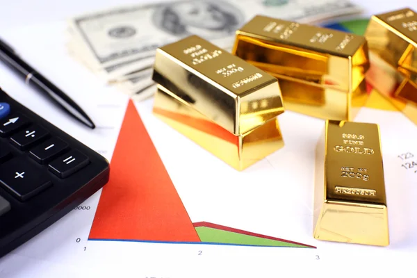 Gold bullion with money on table