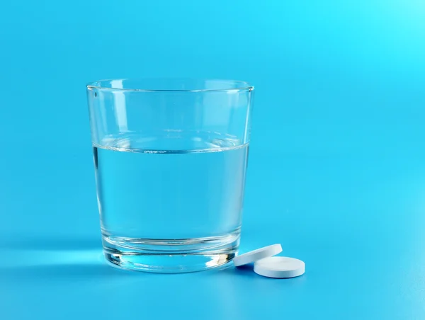 Glass of water and pills