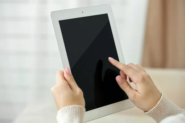 Female hand holding PC tablet