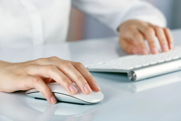 Female hands typing on keyboard
