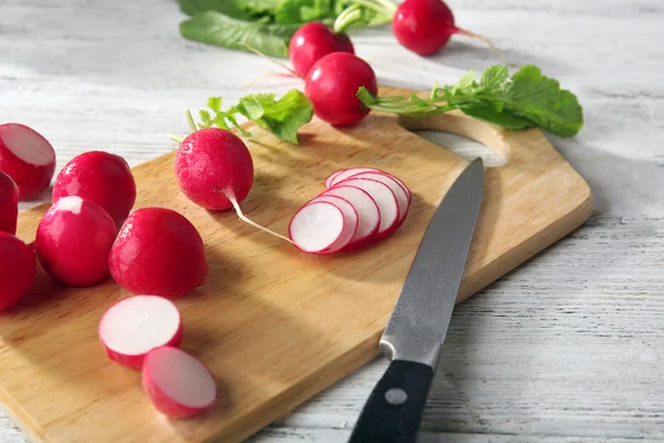 Sliced radishes on cutting board