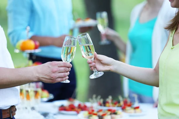 Guests drink champagne on wedding ceremony