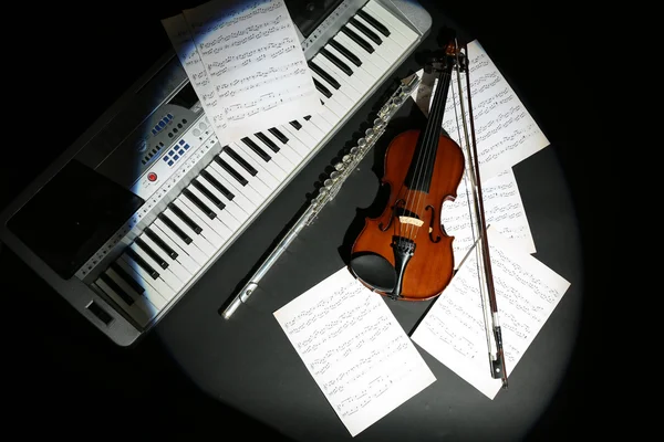 Musical instruments with music notes on dark background