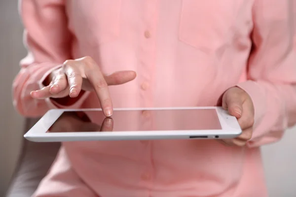 Woman using digital tablet close up