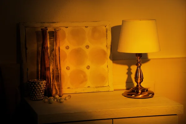 Table lamp on commode in room