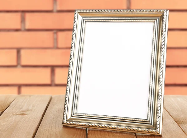 Old empty frame standing on table